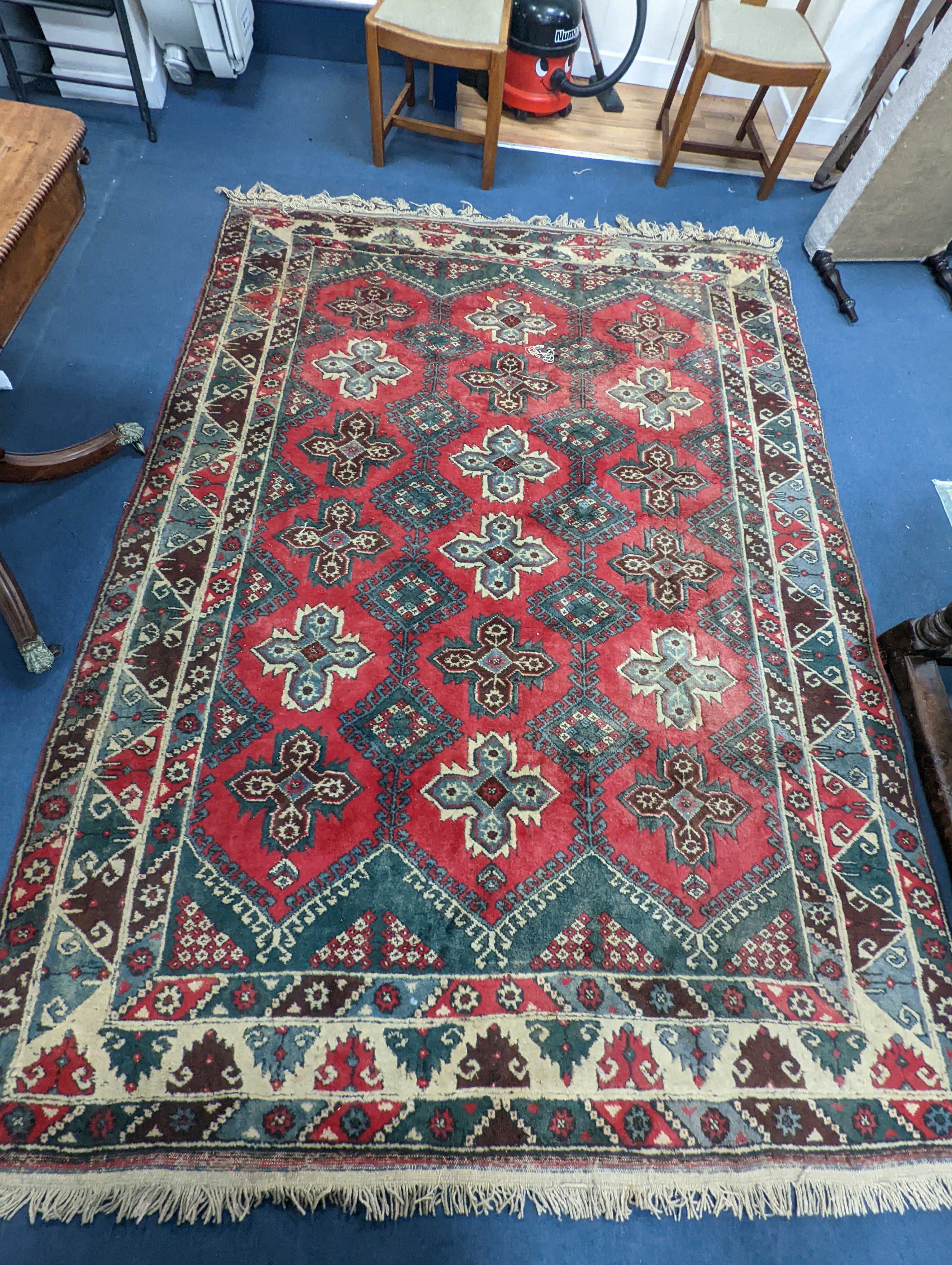 A Caucasian style red ground carpet, 286 x 210cm